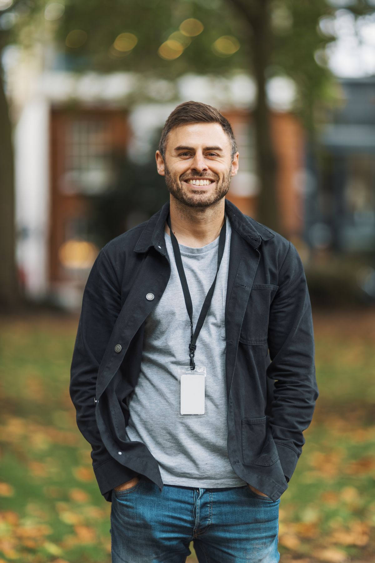 Man in casual clothes smiling in an autumn park